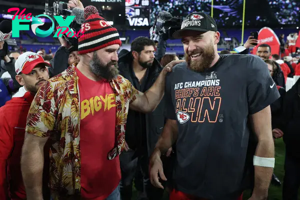 jason and travis kelce on the football field laughing