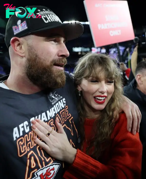 Taylor Swift and Travis Kelce hug each other on the football field.