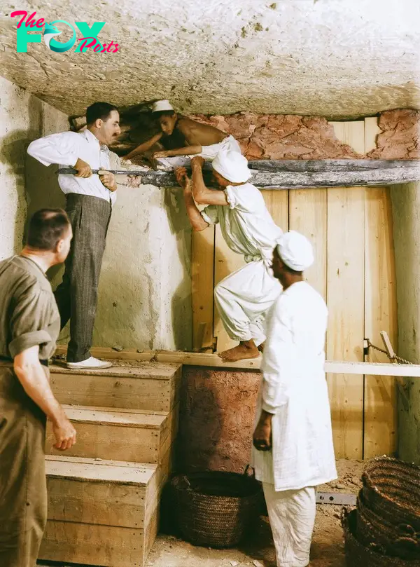 Carter, Callende, and two workers remove the partition wall between the antechamber and the burial chamber, 2nd December 1923. Image courtesy of Griffith Institute, University of Oxford, colourised by Dynamichrome