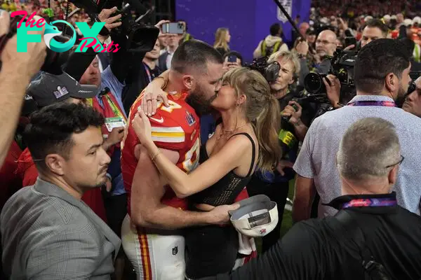 Travis Kelce and Taylor Swift kiss after the Chiefs win the Super Bowl.