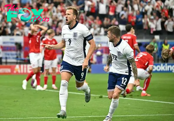 England's forward #09 Harry Kane celebrates scoring his team's first goal next to England's defender #12 Kieran Trippier (R) during the UEFA Euro 2024 Group C football match between Denmark and England at the Frankfurt Arena in Frankfurt am Main on June 20, 2024. (Photo by JAVIER SORIANO / AFP)