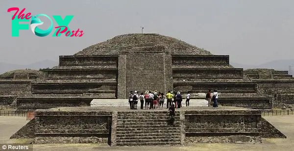 Tourists look on at the archaeological area of the Quetzalcoatl Temple about 37 miles north of Mexico City