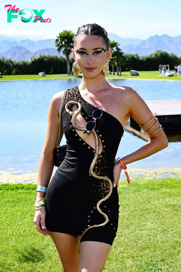 Phoebe Gates in a black-and-gold dress.