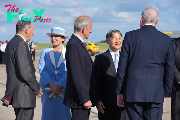 Emperor Naruhito and Empress Masako are greeted by dignitaries as they arrive at Stansted Airport, England, on June 22, 2024.