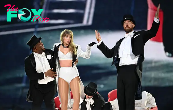taylor swift performing on stage with travis kelce and another dancer