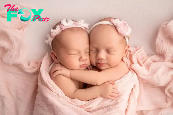 Premium Photo | Tiny newborn twin girls. a newborn twin sleeps next to his sister. newborn twin girls on the background of a pink blanket with pink bandages. the girls gently hug