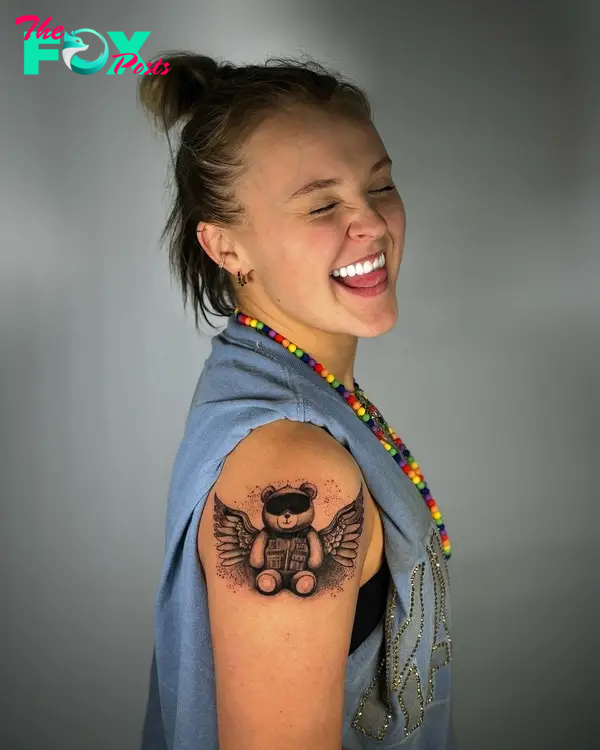 jojo siwa with a winged teddy bear tattoo on her arm