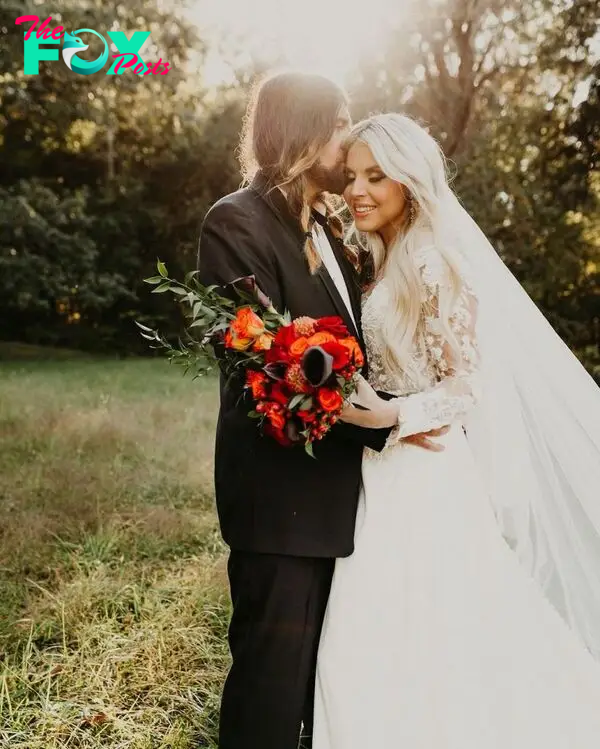Billy Ray Cyrus kisses his wife Firerose Cyrus in a wedding photo