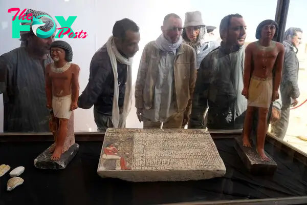 PHOTO: Egyptian antiquities workers watch recently discovered artifacts at the site of the Step Pyramid of Djoser in Saqqara, 24 kilometers (15 miles) southwest of Cairo, Egypt, Jan. 26, 2023.