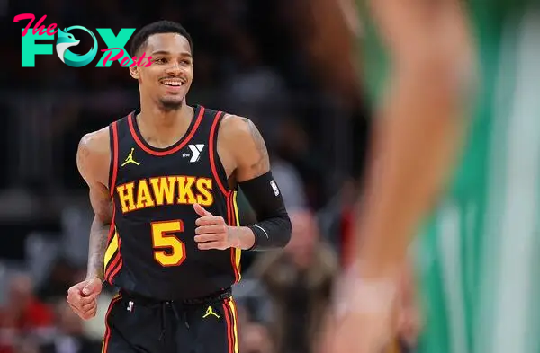 ATLANTA, GEORGIA - MARCH 28: Dejounte Murray #5 of the Atlanta Hawks reacts after a basket against Kristaps Porzingis #8 of the Boston Celtics during overtime at State Farm Arena on March 28, 2024 in Atlanta, Georgia. NOTE TO USER: User expressly acknowledges and agrees that, by downloading and/or using this photograph, user is consenting to the terms and conditions of the Getty Images License Agreement.   Kevin C. Cox/Getty Images/AFP (Photo by Kevin C. Cox / GETTY IMAGES NORTH AMERICA / Getty Images via AFP)