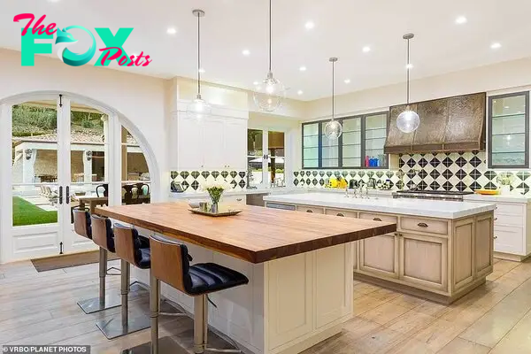 The house has an open bright kitchen (pictured) with stylish interiors and will no douƄt offer the couple priʋacy with its 1.75 acres of land