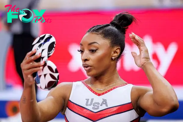 US gymnast Simone Biles looks at herself in a mirror during the Women's Day Four of 2024 US Olympic Gymnastics Trials at the Target Center in Minneapolis, Minnesota, on June 30, 2024. (Photo by Kerem YUCEL / AFP)