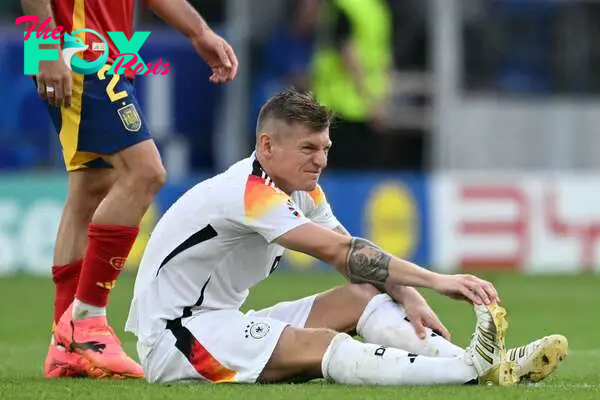 Germany's midfielder #08 Toni Kroos reacts in pain after a cramp during the UEFA Euro 2024 quarter-final football match between Spain and Germany at the Stuttgart Arena in Stuttgart on July 5, 2024. (Photo by THOMAS KIENZLE / AFP)