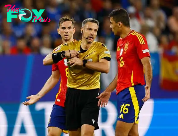 Booked | Spain's Rodri is shown a yellow card by referee Slavko Vincic in the group game against Italy.