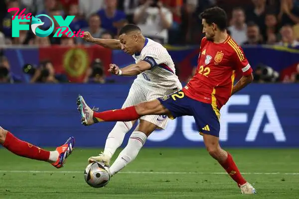 France's forward #10 Kylian Mbappe shoots on target next to Spain's forward #22 Jesus Navas during the UEFA Euro 2024 semi-final football match between Spain and France at the Munich Football Arena in Munich on July 9, 2024. (Photo by FRANCK FIFE / AFP)