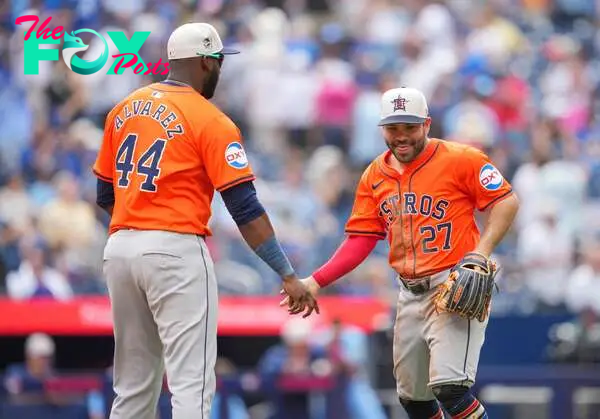 TORONTO, ON - JULY 4: Jose Altuve #27 and Yordan Alvarez #44 of the Houston Astros celebrate defeating the Toronto Blue Jays in their MLB game at the Rogers Centre on July 4, 2024 in Toronto, Ontario, Canada.   Mark Blinch/Getty Images/AFP (Photo by MARK BLINCH / GETTY IMAGES NORTH AMERICA / Getty Images via AFP)