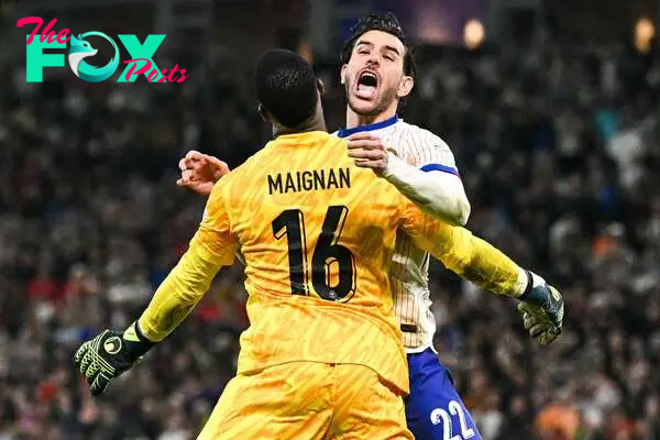 France's defender #22 Theo Hernandez celebrates with France's goalkeeper #16 Mike Maignan after he scored his penalty and qualified France during the UEFA Euro 2024 quarter-final football match between Portugal and France at the Volksparkstadion in Hamburg on July 5, 2024. (Photo by JAVIER SORIANO / AFP)