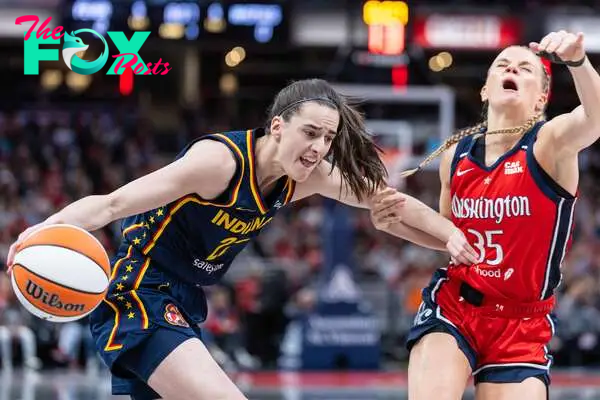 Caitlin Clark #22 of the Indiana Fever dribbles against Julie Vanloo #35 of the Washington Mystics 