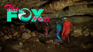 A group of excavators descends into a cave.