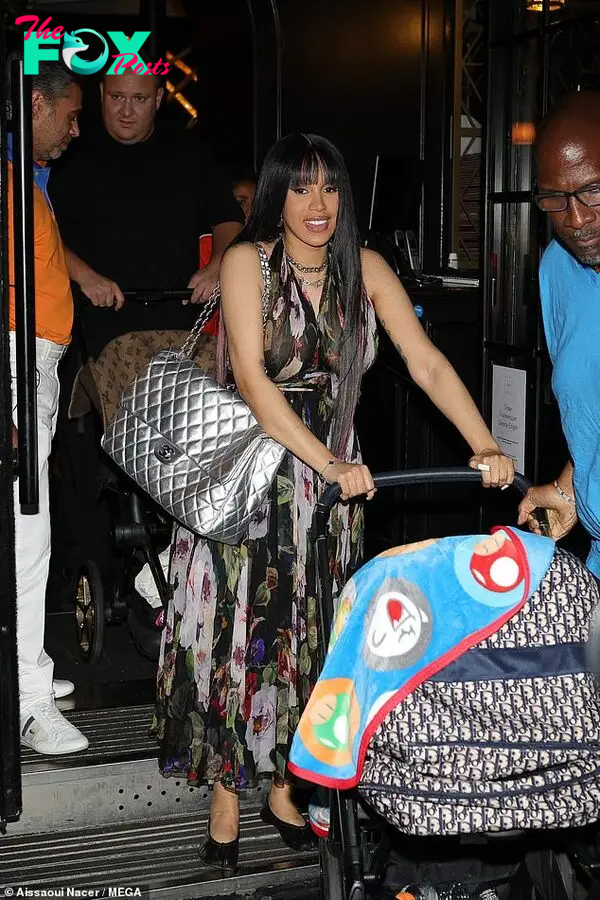 Cardi was wearing a black floral halterneck dress during the outing, which she accessorised with a selection of silver jewellery