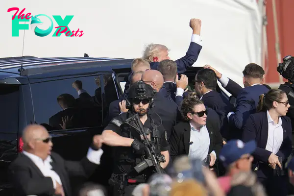 Republican presidential candidate former President Donald Trump pumps his fist as he is helped into a vehicle at a campaign event in Butler, Pa., on July 13, 2024.
