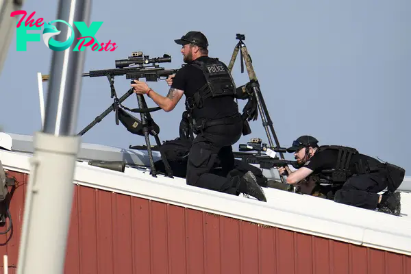 Police snipers return fire after shots were fired while Republican presidential candidate former President Donald Trump was speaking at a campaign event in Butler, Pa., on July 13, 2024.