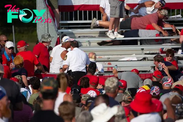 Trump supporters are seen laying in the stands after guns were fired at Republican candidate Donald Trump at a campaign event at Butler Farm Show Inc. in Butler, Pennsylvania, July 13, 2024.