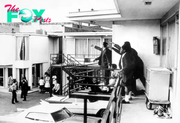Civil rights leader Andrew Young (L) and others standing on balcony of Lorraine motel pointing in direction of assailant after assassination of civil rights ldr. Dr. Martin Luther King, Jr., who is lying at their feet, on April 4, 1968.