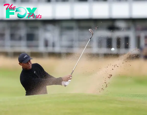 Woods of the USA playing out of a bunker on the 16th hole during a practice round for the Open Golf Championships 2024