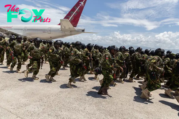 The new Kenyan police contingent disembark after landing on Haitian soil in Port-au-Prince on July 16.