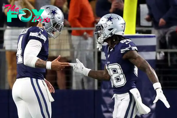 ARLINGTON, TEXAS - DECEMBER 30: CeeDee Lamb #88 of the Dallas Cowboys celebrates with Dak Prescott #4 after scoring a 92 yard touchdown against the Detroit Lions during the first quarter in the game at AT&T Stadium on December 30, 2023 in Arlington, Texas.   Richard Rodriguez/Getty Images/AFP (Photo by Richard Rodriguez / GETTY IMAGES NORTH AMERICA / Getty Images via AFP)