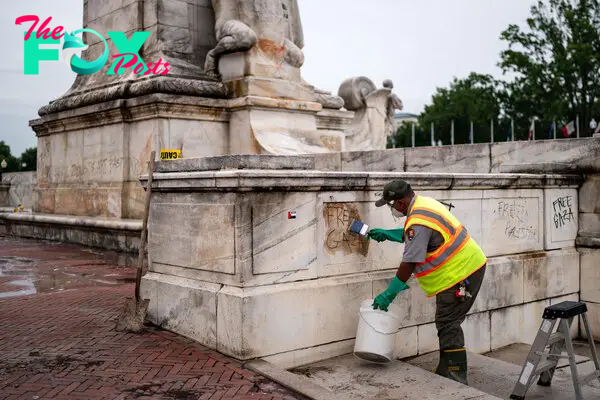 National Park Service workers attempt to remove graffiti at Union Station on July 25, 2024 in Washington, D.C.