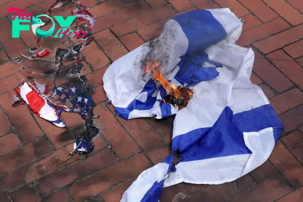 Activists burn a U.S. flag and an Israeli flag during a pro-Palestinian protest near the U.S. Capitol in Washington, D.C., on July 24, 2024.