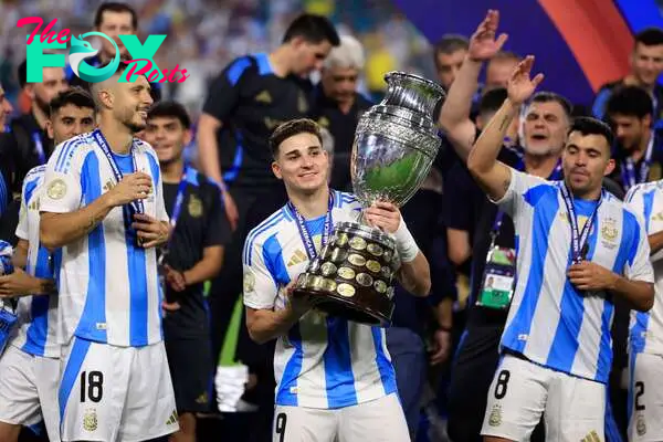 Julian Alvarez of Argentina holds the trophy after the CONMEBOL Copa America 2024 win.