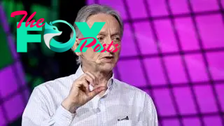 A photo of Geoffrey Hinton speaking at a conference in 2023