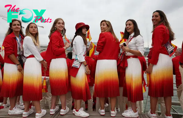 Athletes of Team Spain hold Spanish flags during the opening ceremony.