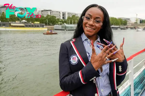 Sha'Carri Richardson poses for a photo while riding on a boat with teammates along the Seine River in Paris, France, during the opening ceremony of the 2024 Summer Olympics, Friday, July 26, 2024. (Photo by Ashley Landis / POOL / AFP)