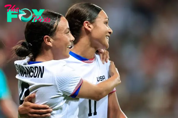 US' forward #09 Mallory Swanson (L) celebrates with US' forward #11 Sophia Smith scoring her team's third goal in the women's group A football match between the USA and Zambia during the Paris 2024 Olympic Games at the Nice Stadium in Nice, on July 25, 2024. (Photo by Valery HACHE / AFP)