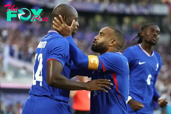 France's forward #14 Jean-Philippe Mateta (L) celebrates with France's forward #10 Alexandre Lacazette after scoring his team's first goal in the men's quarter-final football match between France and Argentina during the Paris 2024 Olympic Games at the Bordeaux Stadium in Bordeaux on August 2, 2024. (Photo by ROMAIN PERROCHEAU / AFP)