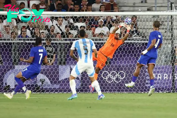 France's goalkeeper #16 Guillaume Restes makes a save in the men's quarter-final football match between France and Argentina during the Paris 2024 Olympic Games at the Bordeaux Stadium in Bordeaux on August 2, 2024. (Photo by ROMAIN PERROCHEAU / AFP)