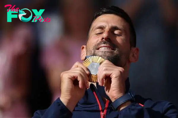 Champion | Novak Djokovic and his medal.