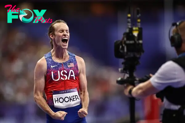 US' Cole Hocker celebrates winning the men's 1500m final of the athletics event at the Paris 2024 Olympic Games at Stade de France in Saint-Denis, north of Paris, on August 6, 2024. (Photo by Anne-Christine POUJOULAT / AFP)