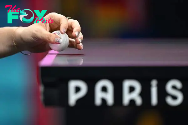 A detailed view of the Olympic Rings painted on the nails of Germany's Yuan Wan during her women's table tennis singles match in the team semifinal between Germany and Japan at the Paris 2024 Olympic Games at the South Paris Arena in Paris on August 8, 2024. (Photo by JUNG Yeon-je / AFP)