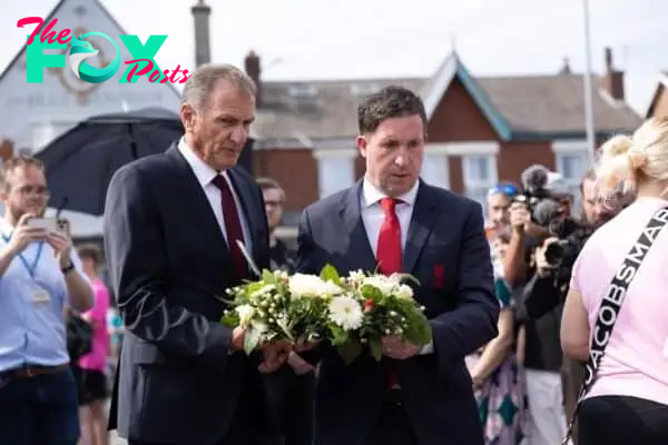 Former Liverpool players Phil Thompson (left) and Robbie Fowler lay flowers near the scene in Hart Street, Southport, where three children died and eight were injured in a ferocious knife attack during a Taylor Swift event at a dance school on Monday. A 17-year-old male from Banks, Lancashire, has been arrested on suspicion of murder and attempted murder over the incident. Picture date: Tuesday July 30, 2024.