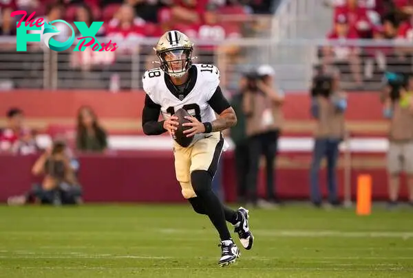 Spencer Rattler, #18 of the New Orleans Saints, scrambles with the ball against the San Francisco 49ers during the first half of a preseason game at Levi's Stadium on August 18, 2024, in Santa Clara, California.   