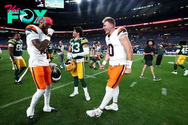 DENVER, COLORADO - AUGUST 18: Troy Franklin #16 and Bo Nix #10 of the Denver Broncos talk with Evan Williams #33 of the Green Bay Packers following the preseason game at Empower Field At Mile High on August 18, 2024 in Denver, Colorado.   Tyler Schank/Getty Images/AFP (Photo by Tyler Schank / GETTY IMAGES NORTH AMERICA / Getty Images via AFP)