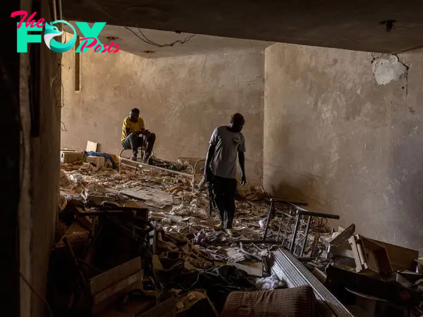 Sudanese military personnel stand guard in the basement of a building that had been used as an arms depot by Rapid Support Forces fighters in Omdurman, Sudan, on April 25, 2024.