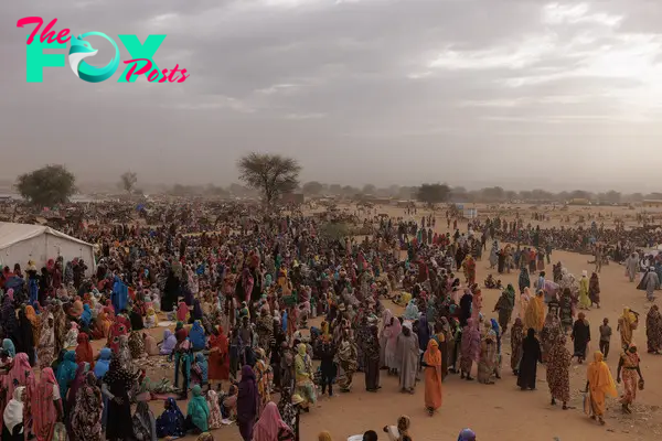 Refugees wait for a WFP food distribution point to open at a temporary camp in Adre, Chad, on April 22, 2024.