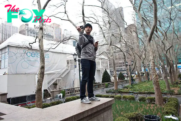 Tim Pool uses his cell phone to live stream a day of action with the Occupy Wall Street movement in New York on February 29, 2012.