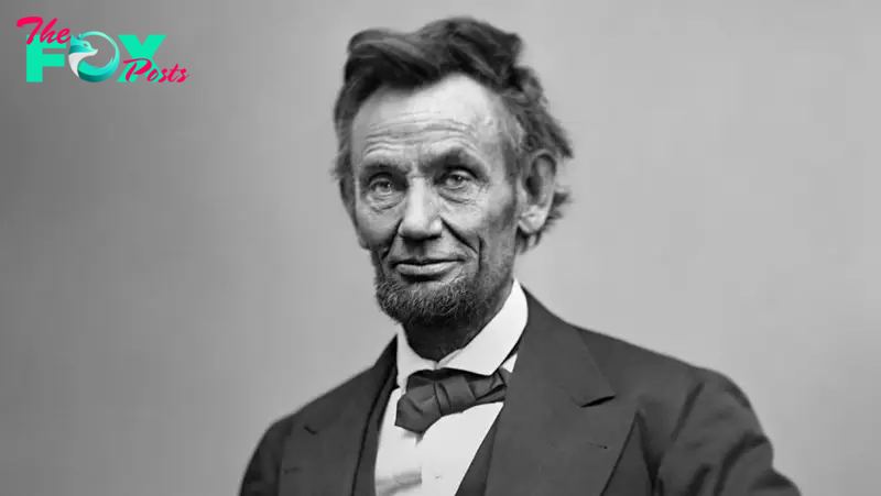 Abraham Lincoln, three-quarter length portrait, seated and holding his spectacles and a pencil, 5 Feb 1865